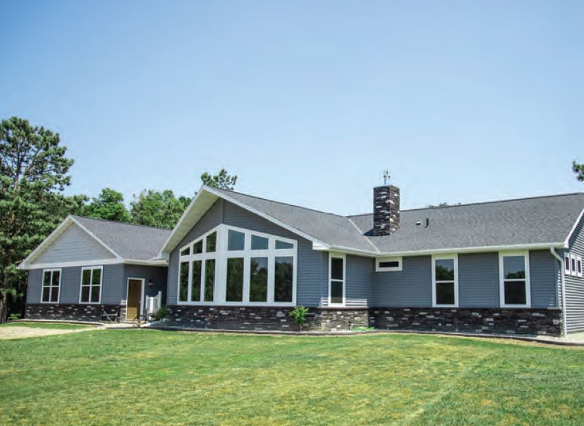 Somerset home with gray siding and a wall of windows